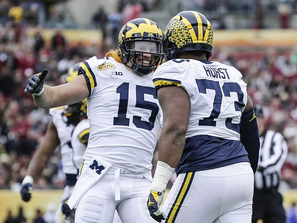 Chase Winovich (15) and Maurice Hurst (73)