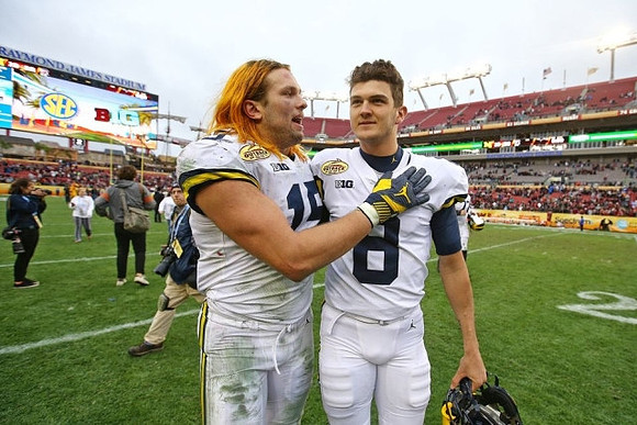 Chase Winovich (15) and John O'Korn (8)