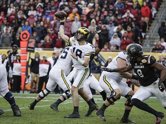 Jon Runyan Jr. (75), Brandon Peters (18), and Mason Cole (52)