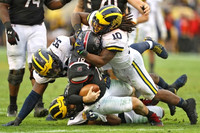 Lawrence Marshall (93), Devin Bush (10), and Chase Winovich (15)