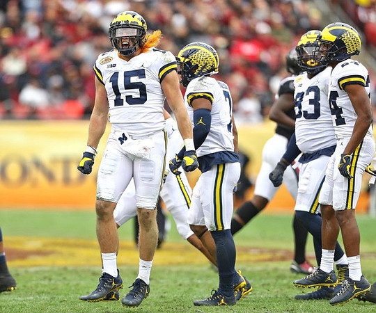 Chase Winovich (15), Khaleke Hudson (7), Lawrence Marshall (93), and Lavert Hill (24)