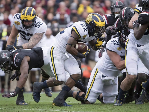 Mason Cole (52), Karan Higdon (22), and Patrick Kugler (57)