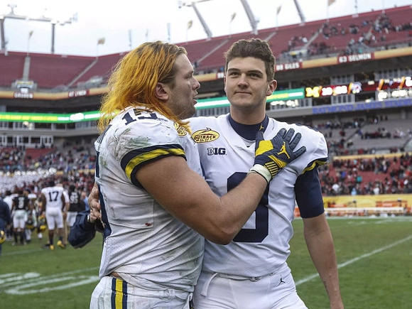 Chase Winovich (15) and John O'Korn (8)