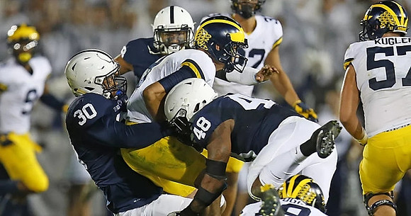 Donovan Peoples-Jones (9), John O'Korn (8), Ty Isaac (32), and Patrick Kugler (57)
