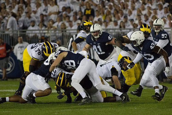 Juwann Bushell-Beatty (76), Karan Higdon (22), John O'Korn (8), Henry Poggi (19), and Michael Onwenu (50)