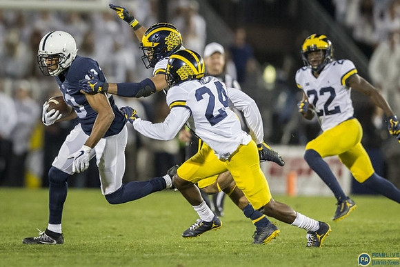 Chase Winovich (15), Lavert Hill (24), and David Long (22)