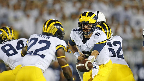 Sean McKeon (84), Karan Higdon (22), John O'Korn (8), and Mason Cole (52)