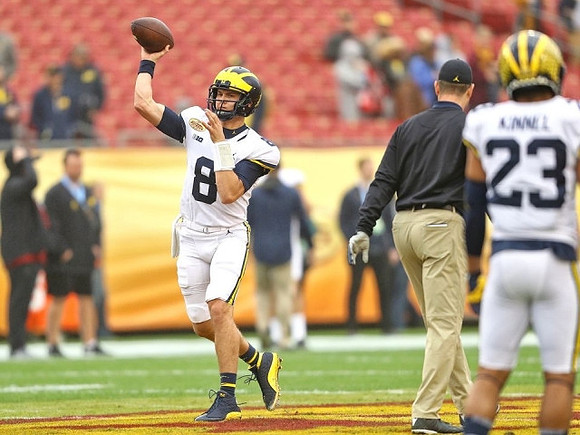 John O'Korn (8), Jim Harbaugh, and Tyree Kinnel (23)