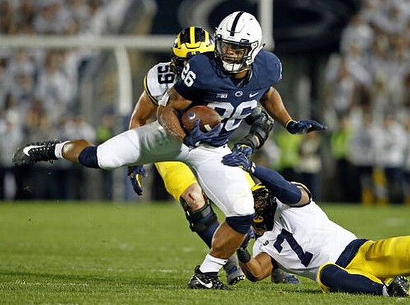 Noah Furbush (59) and Khaleke Hudson (7)