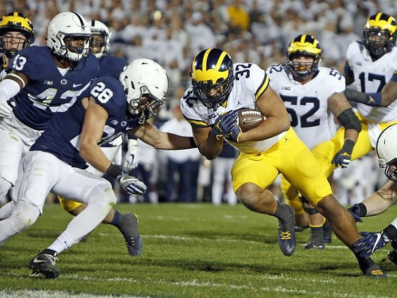 Ty Isaac (32), Mason Cole (52), and Tyrone Wheatley Jr. (17)