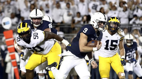 Michael Dwumfour (50) and Chase Winovich (15)