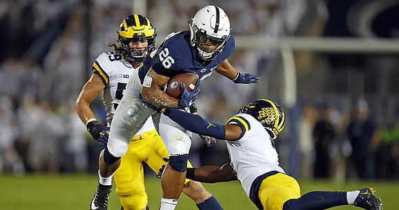 Noah Furbush (59) and Khaleke Hudson (7)