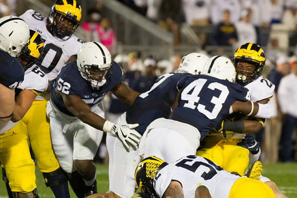 Michael Onwenu (50), Patrick Kugler (57), Mason Cole (52), and Karan Higdon (22)