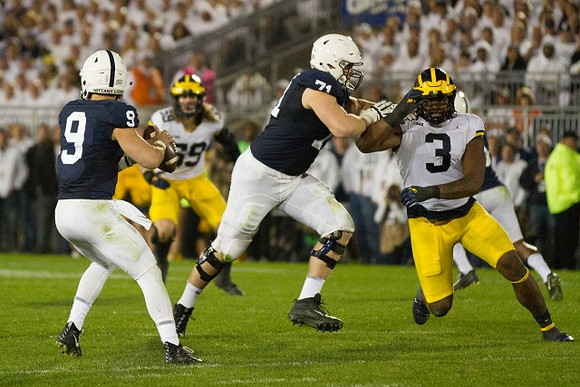 Noah Furbush (59) and Rashan Gary (3)