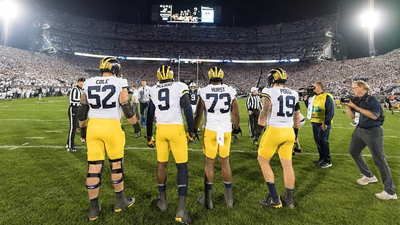 Mason Cole (52), Mike McCray (9), Maurice Hurst (73), and Henry Poggi (19)