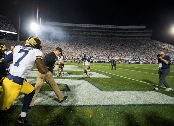 Khaleke Hudson (7) and Jim Harbaugh