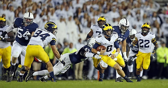 Sean McKeon (84), Jon Runyan Jr. (75), John O'Korn (8), and Karan Higdon (22)