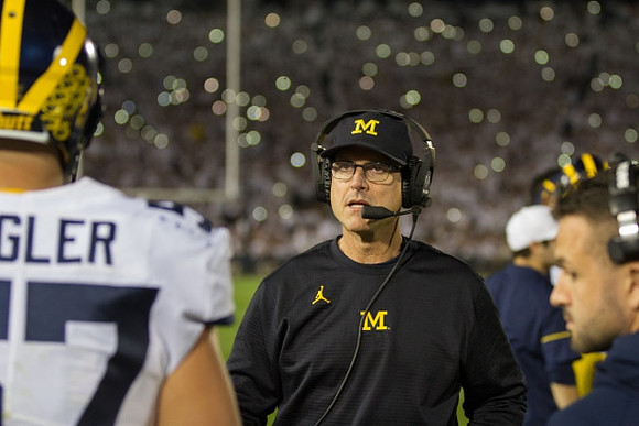 Patrick Kugler (57) and Jim Harbaugh