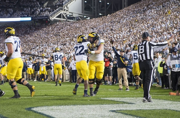 Ben Bredeson (74), Sean McKeon (84), Karan Higdon (22), Patrick Kugler (57), and Mason Cole (52)