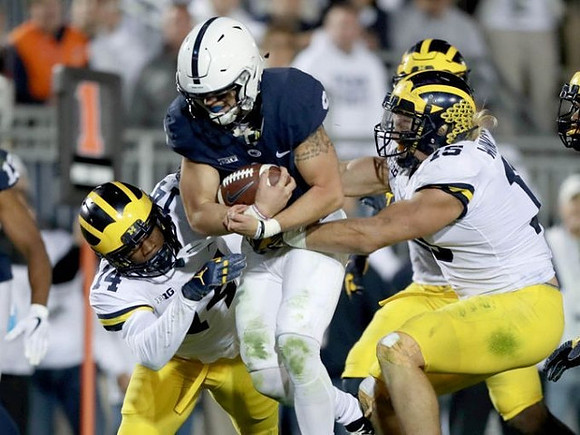 Josh Metellus (14) and Chase Winovich (15)