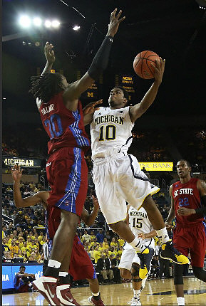 Derrick Walton Jr. (10) and Jon Horford (15)