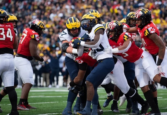 Trevor Keegan (77) and Hassan Haskins (25)