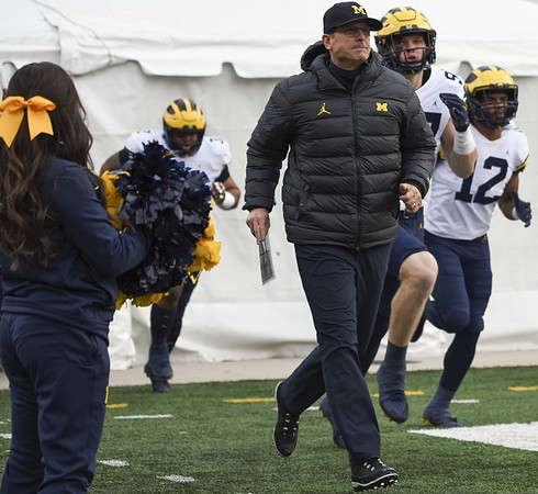 Jim Harbaugh, Aidan Hutchinson (97), and Josh Ross (12)