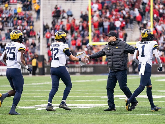 Hassan Haskins (25), Cade McNamara (12), Jim Harbaugh, and Andrel Anthony (1)