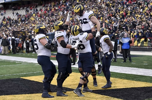 Zak Zinter (65), Ryan Hayes (76), Chuck Filiaga (66), Luke Schoonmaker (86), and Donovan Edwards (7)