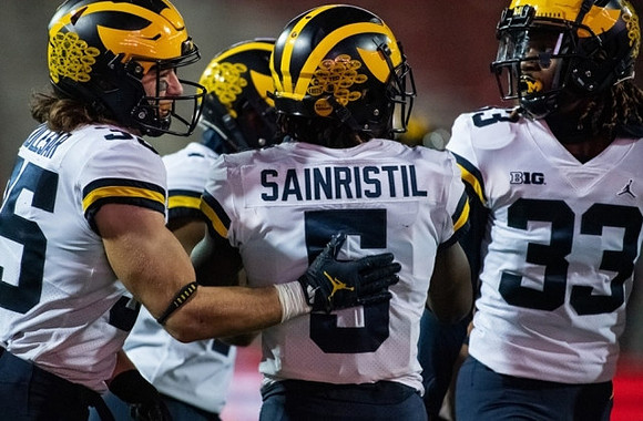 Caden Kolesar (35), Mike Sainristil (5), and German Green (33)