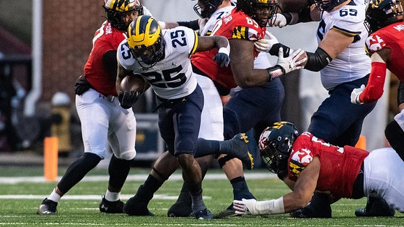 Hassan Haskins (25) and Zak Zinter (65)