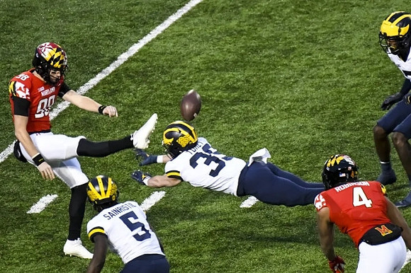 Mike Sainristil (5) and Matt Torey (39)