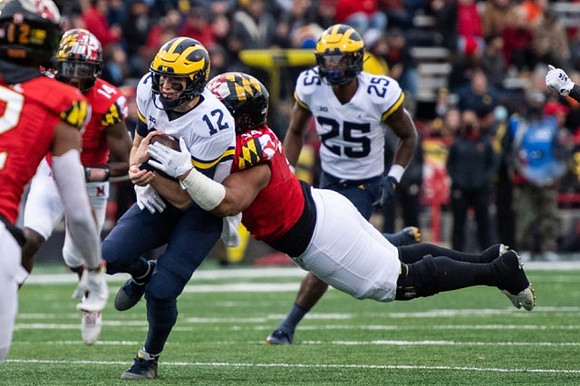 Cade McNamara (12) and Hassan Haskins (25)