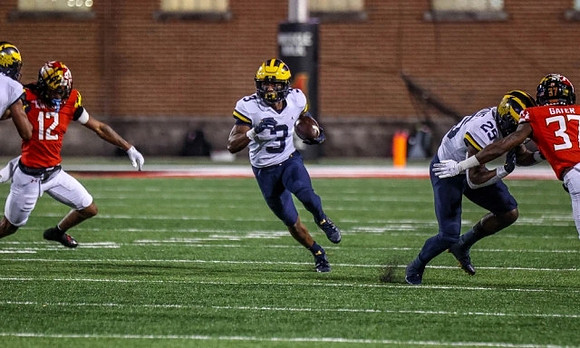 A.J. Henning (3) and Hassan Haskins (25)