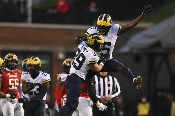 Michael Barrett (23), Matt Torey (39), and Mike Sainristil (5)
