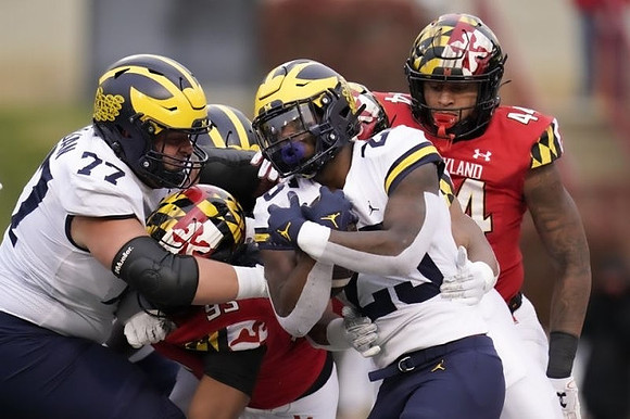 Trevor Keegan (77) and Hassan Haskins (25)