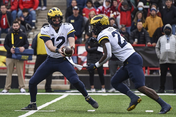 Cade McNamara (12) and Hassan Haskins (25)