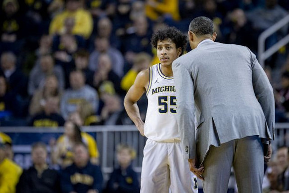 Eli Brooks (55) and Juwan Howard