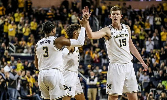 Zavier Simpson (3), Isaiah Livers (2), and Jon Teske (15)