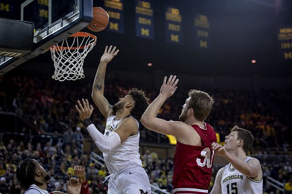 Zavier Simpson (3), Isaiah Livers (2), and Jon Teske (15)