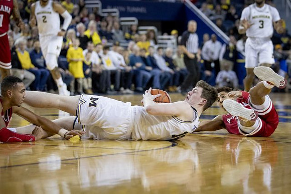 Jon Teske (15), Isaiah Livers (2), and Zavier Simpson (3)