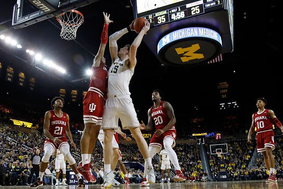 Jon Teske (15) and Zavier Simpson (3)