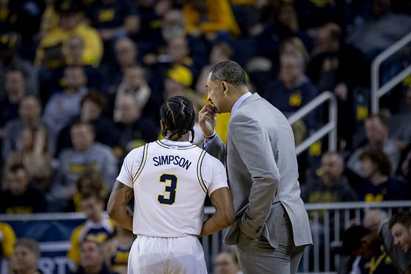 Zavier Simpson (3) and Juwan Howard