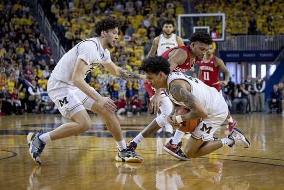 Brandon Johns Jr. (23), Eli Brooks (55), and Isaiah Livers (2)