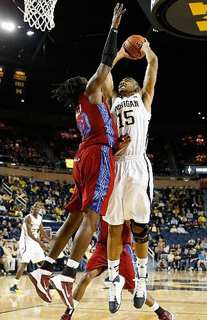 Jon Horford (15) and Caris LeVert (23)