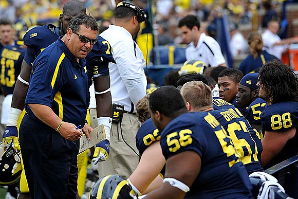 Brady Hoke, Quinton Washington (76), Keith Heitzman (92), Nathan Brink (67), Craig Roh (88), and Ondre Pipkins (56)