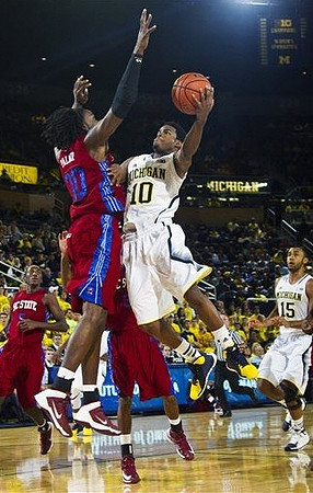 Derrick Walton Jr. (10) and Jon Horford (15)