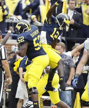 Ricky Barnum (52) and Devin Gardner (12)