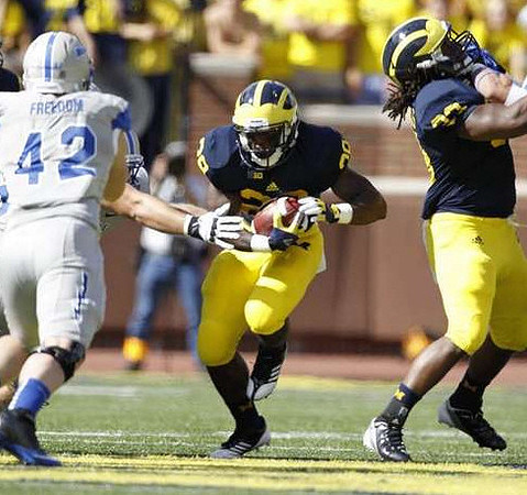 Fitzgerald Toussaint (28) and Denard Robinson (16)