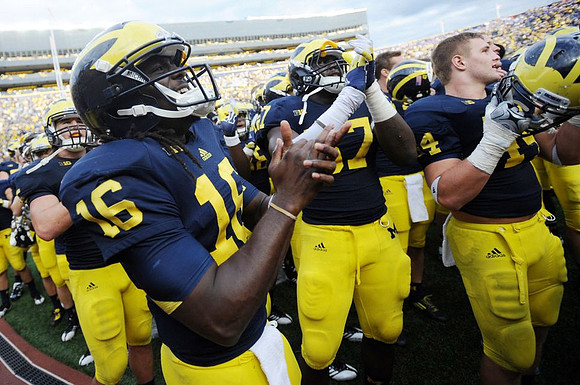Denard Robinson (16), Frank Clark (57), and Steve Wilson (4)